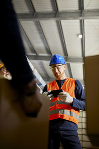 Worker in factory warehouse using tablet