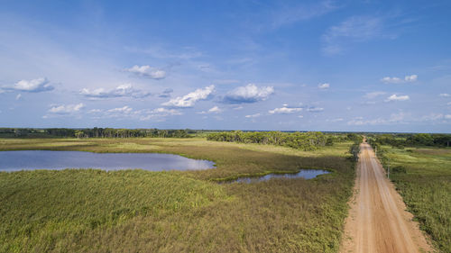 Scenic view of agricultural field against sky