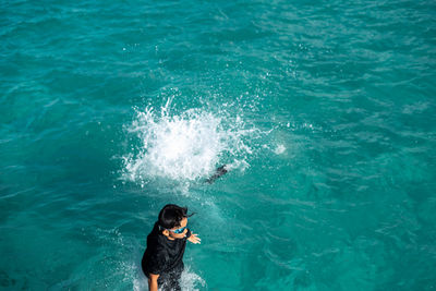 High angle view of woman standing in sea