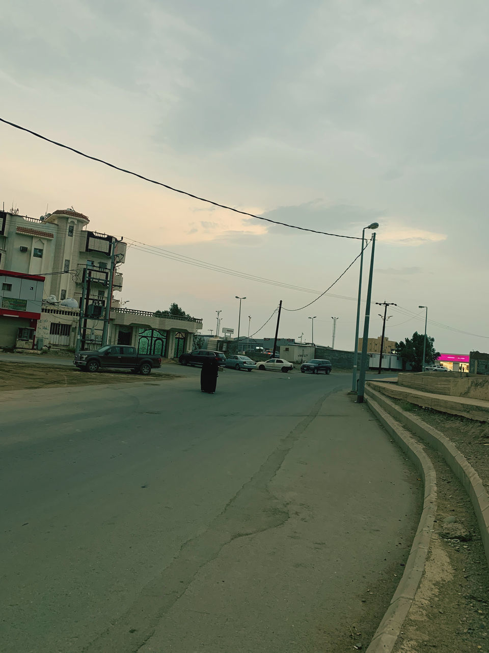 VEHICLES ON ROAD AGAINST SKY