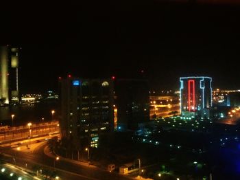 High angle view of illuminated buildings against sky at night