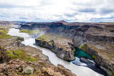 Scenic view of waterfall against sky