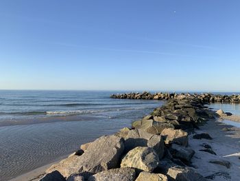 Scenic view of sea against clear blue sky