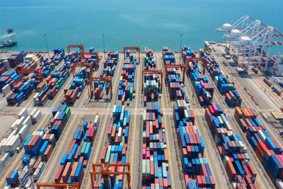 Container ship in export and import business and logistics. shipping cargo to harbor by crane.