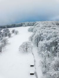 Snow covered landscape against sky