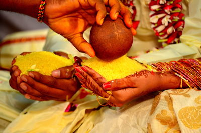 Close-up mid section of indian bride and groom