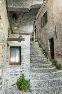 Low angle view of narrow stairs along walls