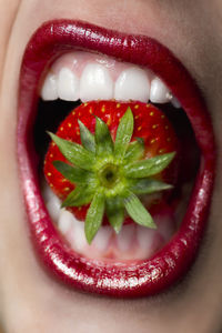 Close-up of woman with strawberries in plate