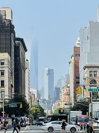 View of city street and buildings against sky