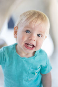 Portrait of cute little infant baby boy child playing on outdoor playground. toddler plays on school