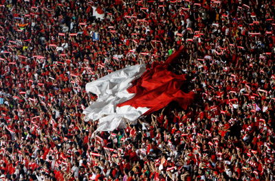 Spectators with indonesian flag in soccer stadium