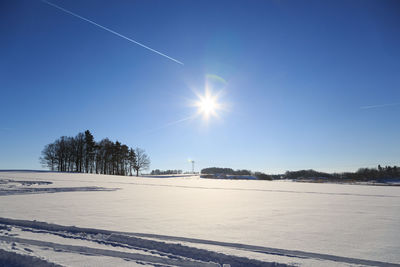 Scenic view of vapor trail against clear blue sky during winter