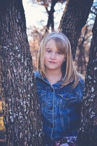 Portrait of smiling girl among trees