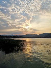 Scenic view of lake against sky during sunset