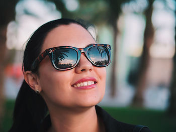 Close-up portrait of smiling young woman