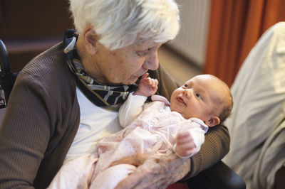 Old woman meeting her great granddaughter