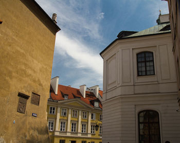 Low angle view of buildings in town against sky