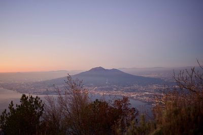 Scenic view of mountains against clear sky at sunset