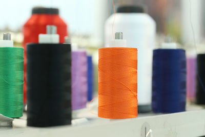 Close-up of multi colored bottles on table