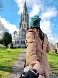 Close-up of man holding hand of woman outdoors