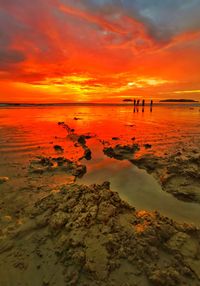 Scenic view of sea against romantic sky at sunset