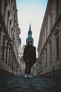 Full length of man amidst buildings in city