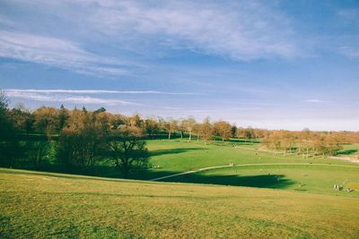 Scenic view of golf course against sky