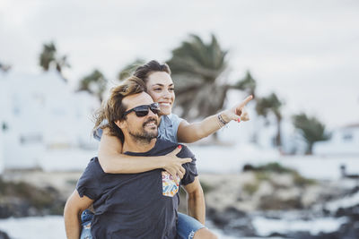 Man and woman with arms raised