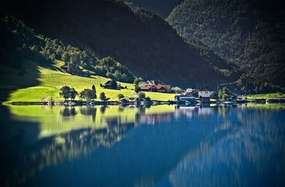 Scenic view of lake by trees against mountain