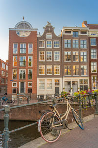 Bicycle by building against sky