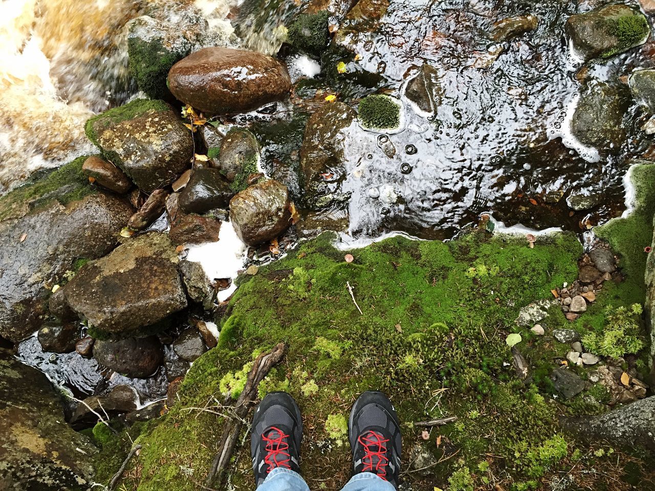 HIGH ANGLE VIEW OF YOUNG WOMAN STANDING ON GROUND