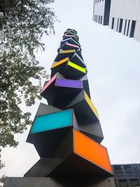 Low angle view of multi colored flags against sky