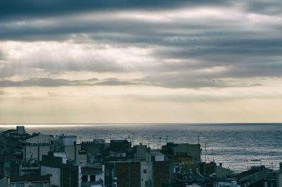 High angle view of buildings by sea against sky