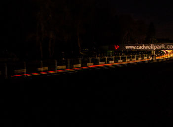 Train on railroad track against sky at night