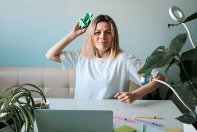 Angry mature woman sitting at table