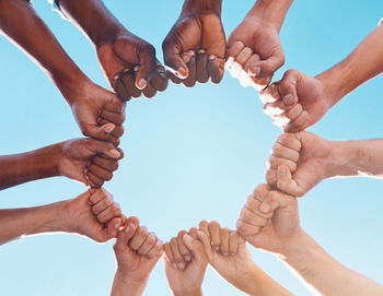 Low angle view of hands against white background