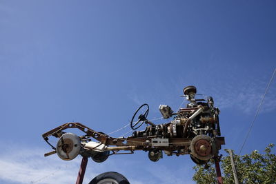 Low angle view of antique car against clear blue sky