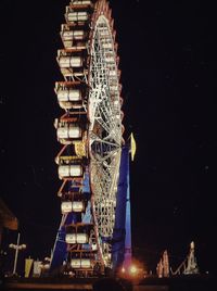 Low angle view of illuminated ferris wheel