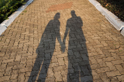 High angle view of people shadow on street