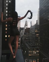Woman with skyscrapers in background