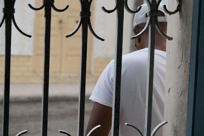 Close-up of clothes hanging on metal fence