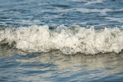 Close-up of waves rushing towards shore