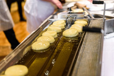 Close-up of breads frying in container