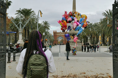 Rear view of people in front of building