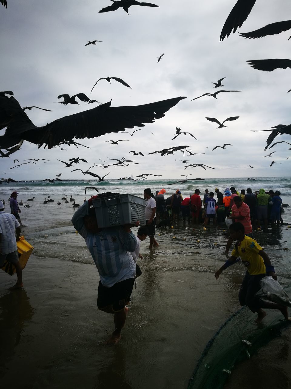 PEOPLE ON BEACH AGAINST SKY