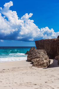 Scenic view of beach against blue sky