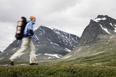 Blurred motion of person walking against mountains