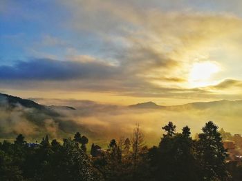 Silhouette of mountains against cloudy sky