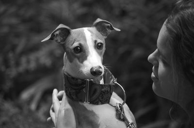 Girl and her italian greyhound looking at camera portrait, in black and white