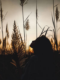 Portrait of silhouette man on field against sky during sunset